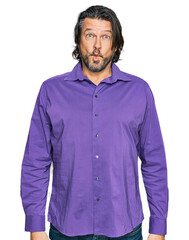 Middle age handsome man wearing business shirt making fish face with lips, crazy and comical gesture. funny expression.