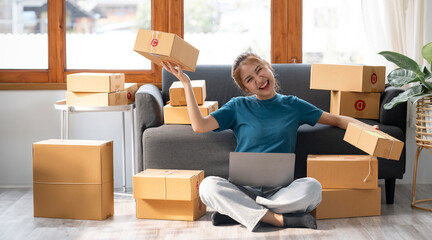 Happy small business owner working online, prepare to pack the boxes for customers, SME business...