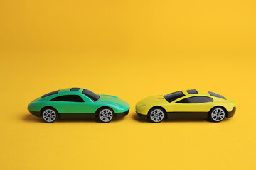 Bright cars on yellow background. Children`s toys