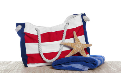 Stylish striped beach bag, starfish and towel isolated on white