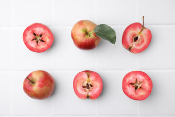Tasty apples with red pulp on white background, flat lay