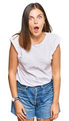 Fototapeta premium Young caucasian woman wearing casual white tshirt afraid and shocked with surprise expression, fear and excited face.