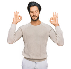 Naklejka premium Young hispanic man wearing casual clothes relax and smiling with eyes closed doing meditation gesture with fingers. yoga concept.