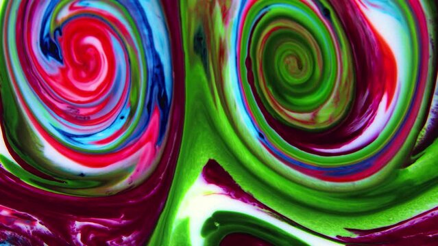 Close-up shot of multi-colored paint mixture boiling in a mixer. They form a unique abstraction that can be used in many video projects, as a background or as a compositing element.