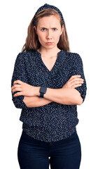 Young beautiful blonde woman wearing casual shirt skeptic and nervous, disapproving expression on...