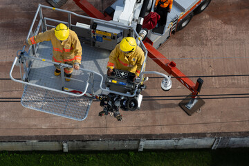 Firefighters in the fire truck crane rescue on building in the citycenter.Firefighters practice a...