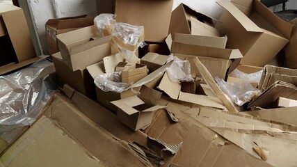 Cardboard and film waste. Used shipping boxes. Sheets or stiff multi layered papers that have been...