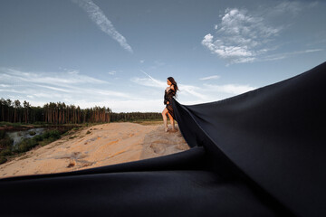Elegant woman in flowing dress on sand dune, evoking freedom and wanderlust. Ideal for fashion,...