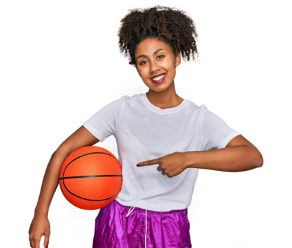 Young african american girl playing baseball holding bat and ball smiling happy pointing with hand and finger - Powered by Adobe