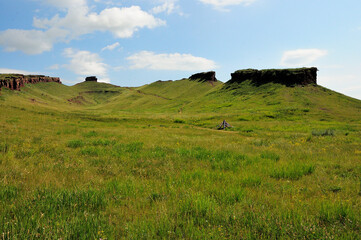 View from the bottom of the hollow on the stone formations along the edges of the high hill. Mountain range