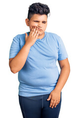 Little boy kid wearing sports workout clothes touching mouth with hand with painful expression because of toothache or dental illness on teeth. dentist
