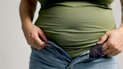 Fat  woman zipping up trousers, excess belly fat, unhealthy lifestyle - obrazy, fototapety, plakaty