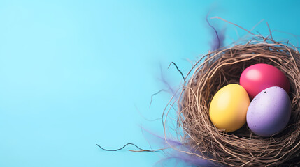 three colorful painted Easter eggs in nest on blue background