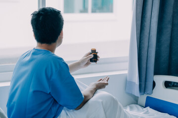 patient sat on the bed and looked out the window in the hospital alone and had stress, boredom,...