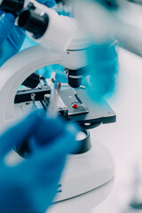 biochemical research scientist team working with microscope for coronavirus vaccine development in...
