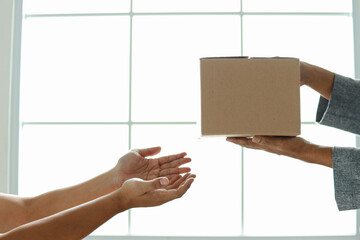Hand giving cardboard box for  donation or charity  