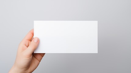 Obraz premium Male hand holding sheet of paper isolated on white background.