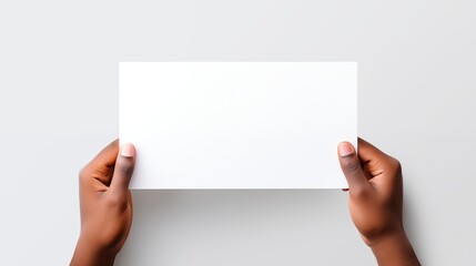 A human hand holding a blank sheet of white paper or card isolated on white background.