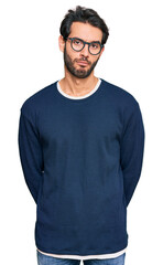 Young hispanic man wearing casual clothes and glasses depressed and worry for distress, crying angry and afraid. sad expression.