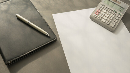 background image . Folder, pen, calculator and white sheet of paper on the table. - obrazy, fototapety, plakaty