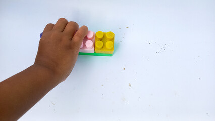 Children hands play with colorful blocks