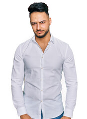 Young arab man wearing casual clothes skeptic and nervous, frowning upset because of problem. negative person.