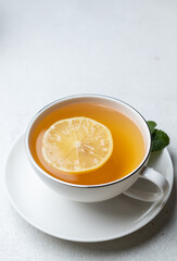 A cup of tea with lemon and ginger and mint