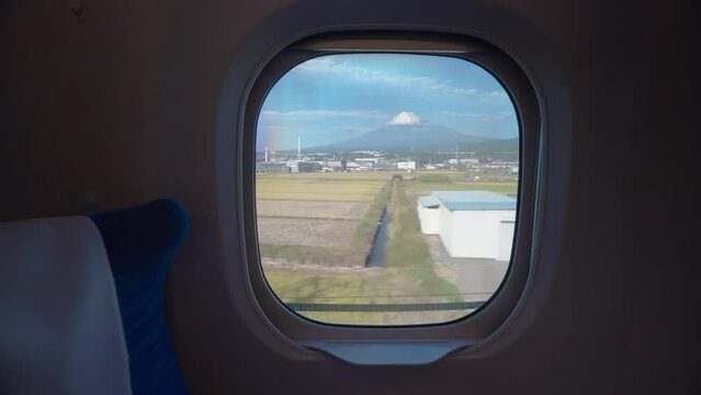View of Mount Fuji through the window onboard a high speed train in Japan