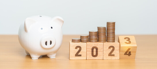 Happy New Year with piggy bank and flipping 2023 change to 2024 block. Resolution, Goals, Plan,...
