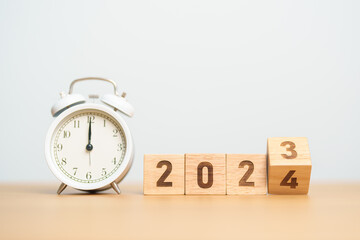 Happy New Year with vintage alarm clock and flipping 2023 change to 2024 block. Christmas, New...