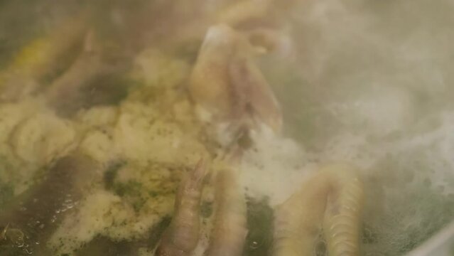 boiling chicken paws - full-frame closeup background with slow motion