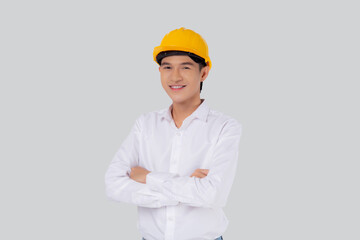 Portrait young asian man is engineer wearing helmet standing and smiling with confident isolated on...