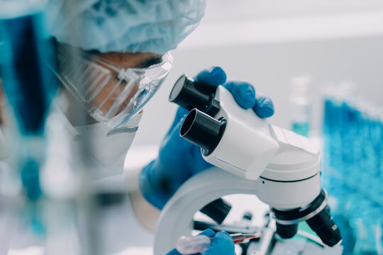 microscope with lab glassware, science laboratory research and development concept