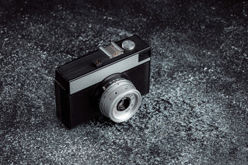 Old mechanical film camera. Long range hipster camera. Minimalist monolithic design of the camera...