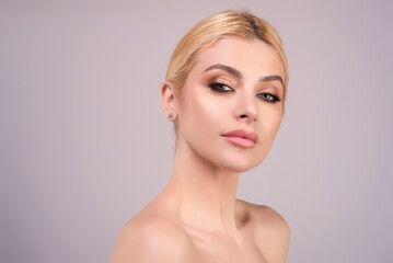 Beauty woman eyes, healthy pure skin, natural make up. Beautiful face of beauty young model. Portrait of pretty girl enjoying beauty treatment on studio background. Beauty woman.