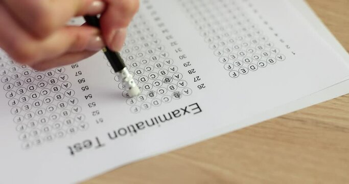 Student erases answer on exam form with eraser on pencil
