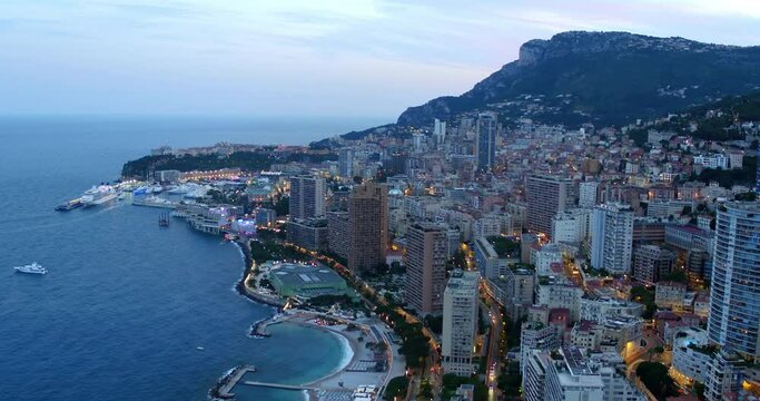 Aerial Panning Scenic Shot Of Buildings And Harbor In Residential City At Dusk - Monte Carlo, Monaco