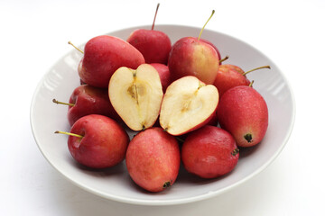 Fresh small red apples on white background