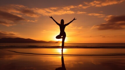 Silhouette of young woman practicing yoga on the beach at sunset, Young woman practicing yoga in the Natarajasana position