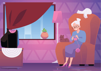 Happy old woman knitting and sitting in big armchair with cute cats