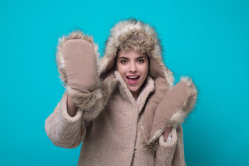 Funny excited Woman in winter warm hat and Winter gloves. Fun girl in woolen coat. Girl in winters...