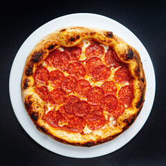pizza on the black background, top view