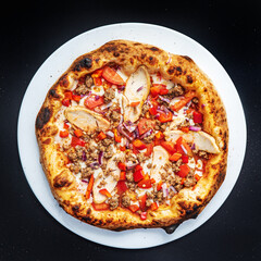 pizza on the black background, top view