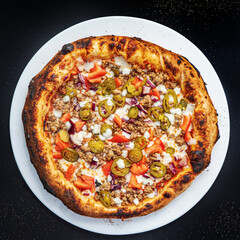pizza on the black background, top view