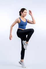 Side view young athletic asian woman on running posture in studio shot on isolated background....