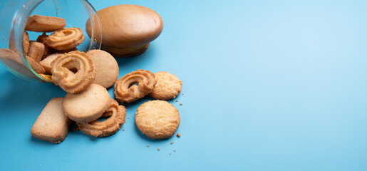 Fototapeta na wymiar Jar of cookie on blue background,Space for text and content