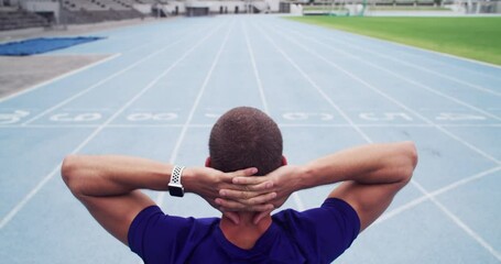 Rear view, man or athlete on racing track for runner, fitness and training on stadium with workout. Person, back or running field for thinking, competition or athletics outdoor for wellness and sport
