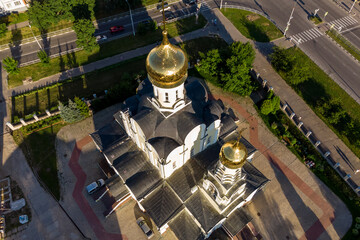 Drone view of golden domes with crosses on an Orthodox church in the city of Obninsk, Russia