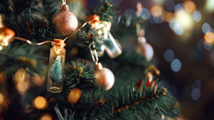 Closeup - Elegant Christmas tree in glass jar with bokeh lights on Christmas tree, Christmas and new year concept. - obrazy, fototapety, plakaty