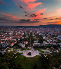 Budapest, Hungary - Aerial panoramic view of the Museum of Ethnography at City Park with the skyline of Budapest at background and colorful sunset over the capital of Hungary